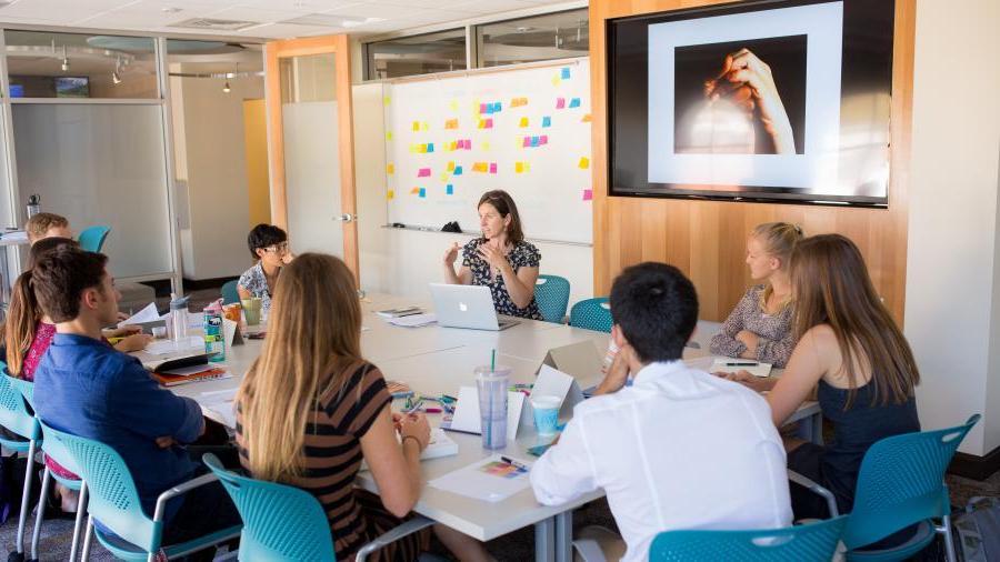 Students innovating around a table